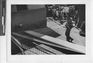 A man spinning cotton at Yunnan, China, 1945