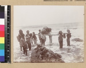 Missionary being transported along coast, Delena, Papua New Guinea, ca. 1905-1915