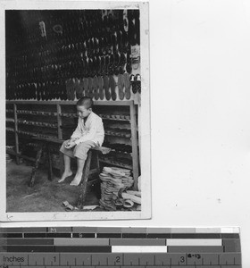 A boy in a shoe shop at Stanley, Hong Kong, China, 1939