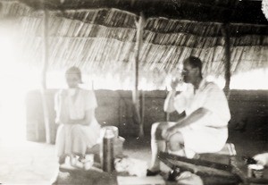 E.G & Mrs Lloyd having tea by wayside from Egedi, Nigeria, ca. 1936