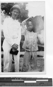 Rev. Mark A. Churchill, MM, with a boy at Luoding, China, 1931