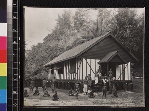 Portrait of men, women and children outside mission building, Mailu, Papua New Guinea, ca.1910-1920