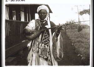 A Hausa musician outside the mission house in Fumban