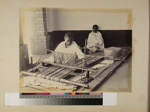 Malagasy woman sitting by a loom weaving, Madagascar