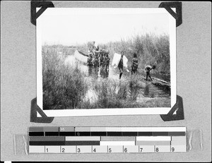 Loading a boat on the Mebasi River, Mwaya, Tanzania, 1936