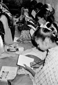 Teaching of girls in a pre-school class on the pavement at Calcutta's slum area, North India No