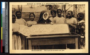 Missionary sister teaching girls how to embroider, Madagascar, ca.1900-1930