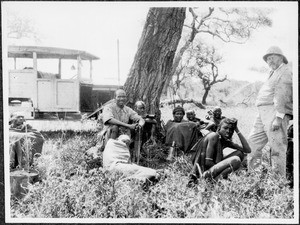 Missionary Blumer with a group of Maasai at a truck, Tanzania, ca. 1927-1930