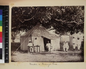 Missionaries sitting outside tent with Indian men, India, ca.1885-1889