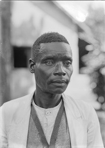 African man wearing light-colored jacket, Tanzania, ca.1893-1920