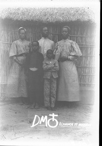 Group of African people in front of a hut, Mozambique, ca. 1896-1911