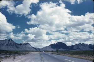 Cars driving toward mountains