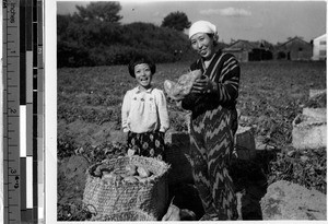 Farmer woman and daughter holding sweet potato, Japan, ca. 1946