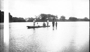 Swiss missionary and African people on a pirogue, southern Africa