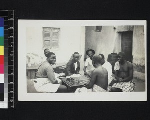 Men playing board game, Ghana, 1926