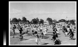 Students, faculty, and children doing exercises at Athletics Day, Yenching University, Beijing, China, 1938