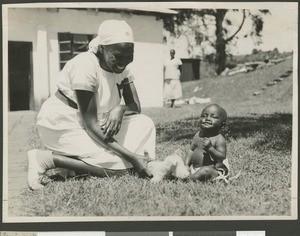 Nurse playing with baby, Chogoria, Kenya, ca.1948