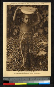 Child holding a bowl of food, Togo, Africa, ca. 1920-1940