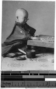 Boy playing a board game, Japan, ca. 1920-1940