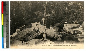 Male missionaries on rocks in a river, India, ca.1920-1940