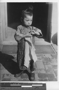 A little boy with a new hair style at Fushun, China, 1937