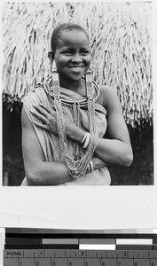 Bakuria woman standing in front of a hut, Africa, ca. 1920-1940