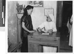 Sister talking to patient, Toishan, China, ca. 1948