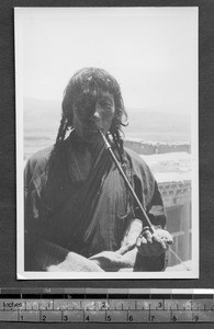 Tibetan man with pipe, Tibet, China, ca.1941