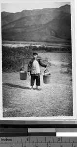 Woman carrying buckets, Tung Shek, Kaying, China, 1934