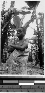 Boy standing outside with his arms folded, Africa, March 1948