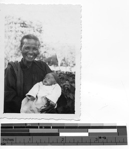 An orphan with her nurse at Luoding, China, 1936