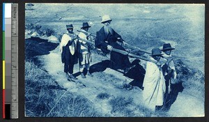 Missionary priest in open sedan chair, Madagascar, ca.1900-1930