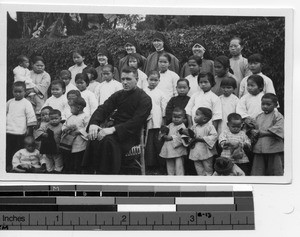 Fr. R. Kennelly with orphans at Luoding, China, 1934