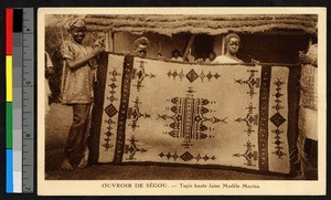 People holding up a woven rug, Sudan, ca.1920-1940