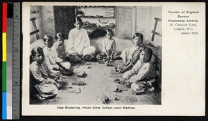 Woman and children working clay indoors, India, ca.1920-1940