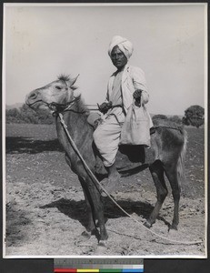 Leper riding donkey, India, ca.1919-1943