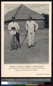 Indigenous men in suits near the mission church at Kialou, Congo Republic, ca.1900-1930