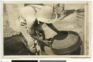 Worker with a sieve on a diamond field, South Africa