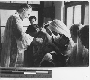 Fr. O'Donnell baptizing at Fushun, China, 1936