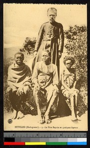 Missionary father with seated lepers, Madagascar, ca.1920-1940