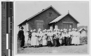 Father Chisholm, MM, with group of women and children, Chungwha, Korea, April 1931