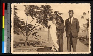 Man standing with woman and infant, South Africa, ca.1920-1940