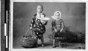 Two children with baskets, Japan, ca. 1920-1940