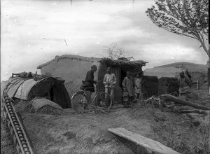 Fr. Anthony Cotta, MM, visting a Chinese family, China, ca. 1906-1919