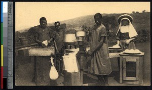 Missionary sister and indigenous adults making butter, Congo, ca.1900-1930