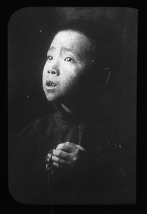 Boy holding rosary beads, China, ca. 1918-1938