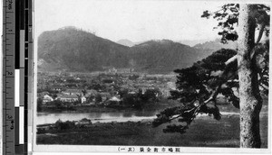 View of a city from across a river, Japan, ca. 1920-1940