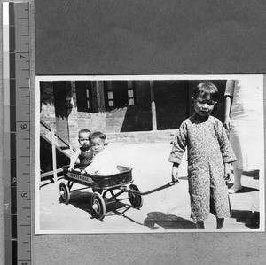 Children riding in a wagon, Fenyang, Shanxi, China, ca.1936-37