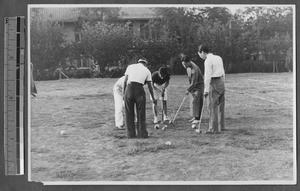 Discussing a play in croquet, Jinan, Shandong, China, 1941