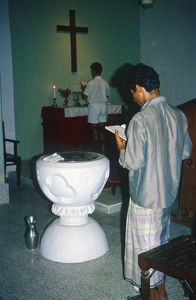 Baptism in the Church of South Arabia. Rev. Verner Tranholm-Mikkelsen in front of the alter